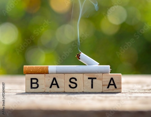 A broken cigarette rests on wooden blocks spelling 