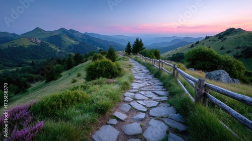Scenic Stone Path Through Green Mountain Landscape at Dusk Serene Nature Trail with Lush Vegetation and Distant Mountain Views Tranquil Outdoor Scenery