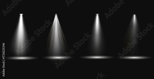 Four bright spotlights shine on a dark stage. Spotlights create dramatic lighting. Each spotlight casts a focused beam. Spotlights illuminate the stage.