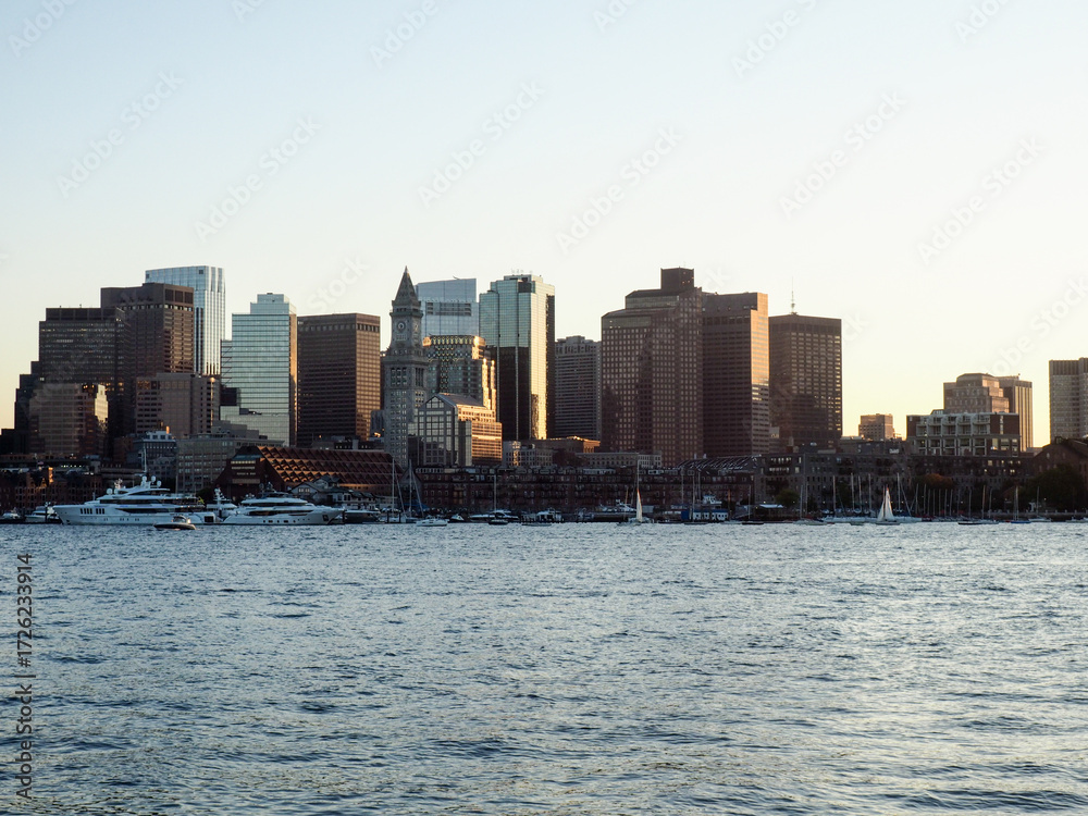 Fototapeta premium A breathtaking city view through the river, where the skyline reflects on calm waters and the urban lights blend with nature’s serenity. This scene captures the harmony between city life and natural