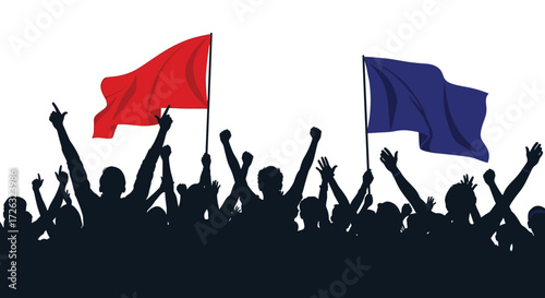 A crowd of people with their hands raised in the air below two flags.