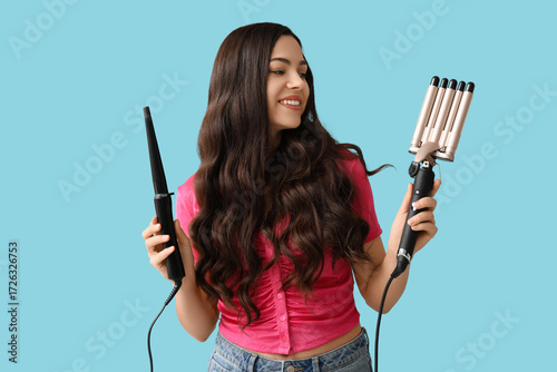 Smiling young woman holding...