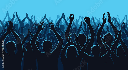 A large silhouette crowd applauding enthusiastically during an event with blue lighting.