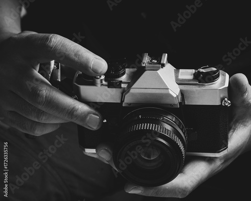 Vintage camera in gentle hands invites a nostalgic journey into photography's past, capturing moments that resonate with timeless artistic expression