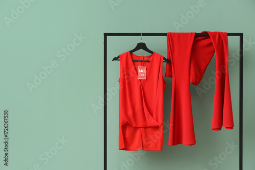 Rack with red clothes and s...