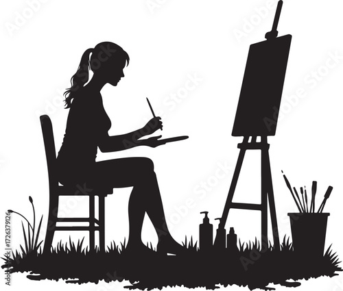 Black silhouette of woman painting outdoors on easel