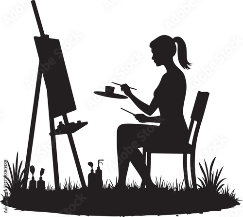 Black silhouette of woman painting on easel outdoors