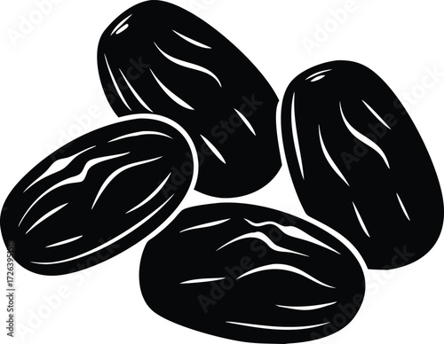 Four dark dried raisins on a white background