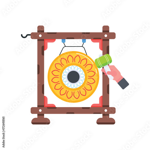 A gong gold with a concentric design suspended in a frame struck by a mallet held by a hand