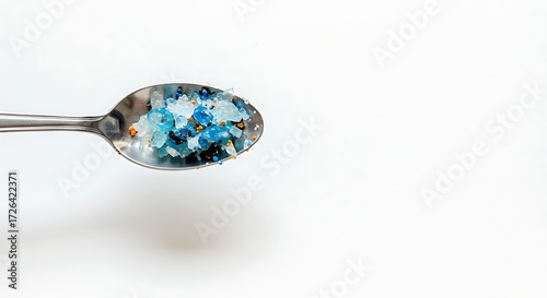 Recycled plastic particles on spoon