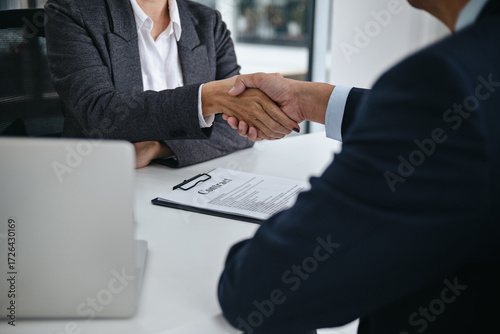 Lawyer with lawsuit meeting with client discussing with contract agreement at law firm
