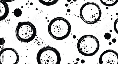Abstract pattern of distressed black circles and scattered dots on a white background.