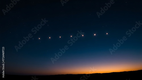 Six bright points of light aligned in the twilight sky above a dark, silhouetted horizon.