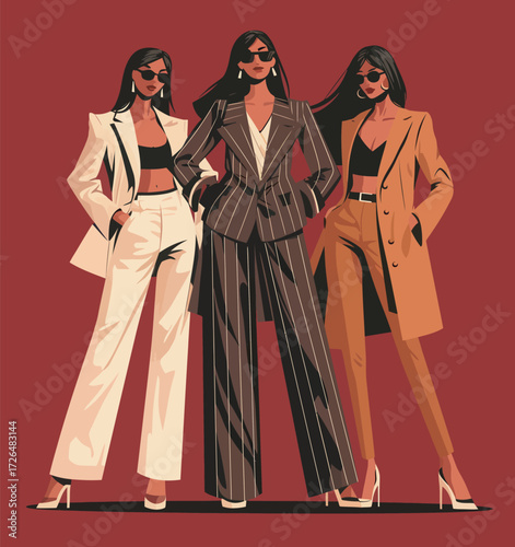 Three women stand with confidence, each in stylish outfits. Their looks feature tailored suits and trendy accessories, embodying contemporary fashion.