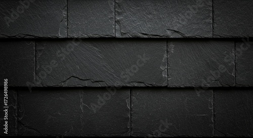 Dark textured slate roof tiles provide a natural, modern building material backdrop.