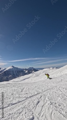 Snowboarder rides and shreds groomed ski piste in slow motion
