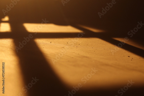 shadows on the wall when sunlight enters. The golden light creates aesthetic silhouettes and geometric patterns.