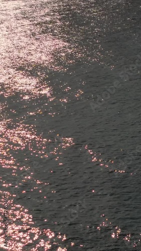 Water surface with golden reflections on beach background. Royalty high-quality free best stock of sunlight reflecting on the ocean waves, Use for backgrounds, tranquility, spirituality