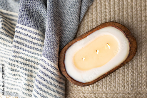 Overhead view of rustic home decor bread bowl candle and cozy throw