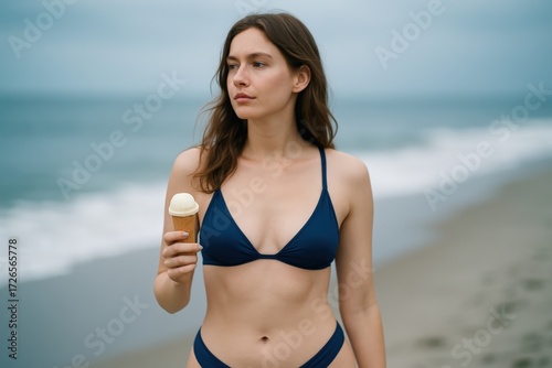 Young Woman Wearing Blue Bikini Holding Ice Cream on Beach
