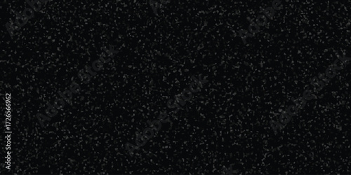 Dark textured background with scattered small grey irregular shapes and subtle light variations abstract