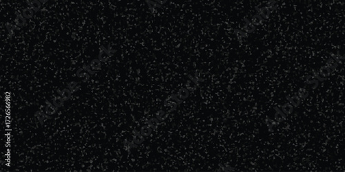 Dark textured background with small irregular grey and black mosaic fragments creating a speckled abstract pattern