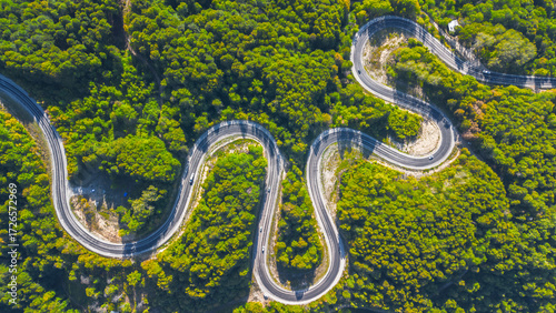 Aerial view of winding asphalt mountain road among green trees in summer. (Domaniç,İnegöl dağ yolu)	