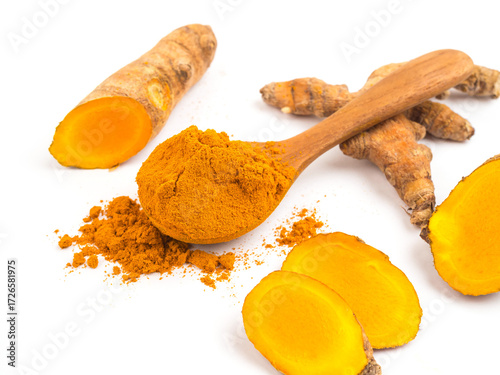 Turmeric powder and fresh turmeric (Curcuma) in wood spoon on white background. herbal