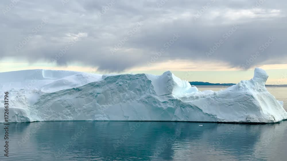 custom made wallpaper toronto digitalMajestic iceberg floats in calm waters under soft clouds during early morning light
