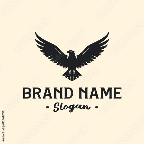 Black eagle or hawk logo with spread wings above a brand name and slogan, on a light background, representing corporate identity.