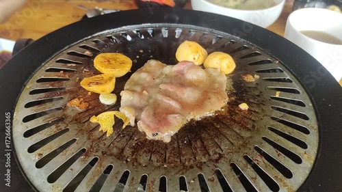 grill a piece of meat with aplly a seasoning and sliced beef barbeque