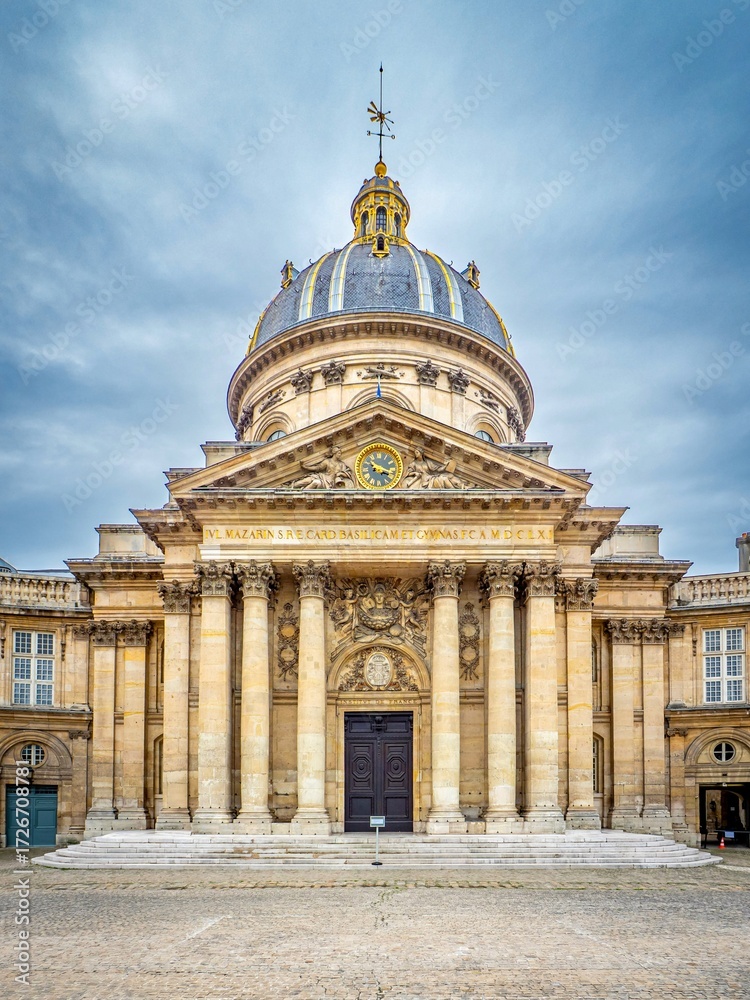 Obraz premium Institut de France in Paris, France, with its grand neoclassical dome, Corinthian columns, and ornate facade under a cloudy sky, an iconic French architectural landmark.