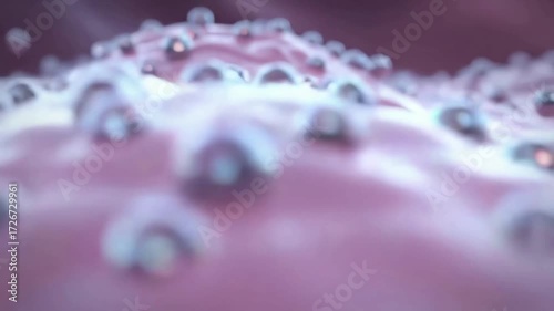 Abstract 3D animation of silver nanoparticles or metallic spheres flowing over a soft pink organic cellular surface representing science and technology.