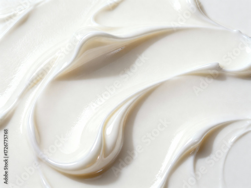 Close up shot of thick white cream with swirls and ripples filling the entire frame of the image
