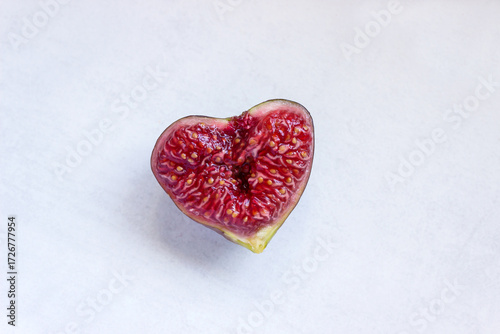 Ripe figs in the shape of a heart. The concept is a healthy diet, vegetarianism, and a Mediterranean diet.