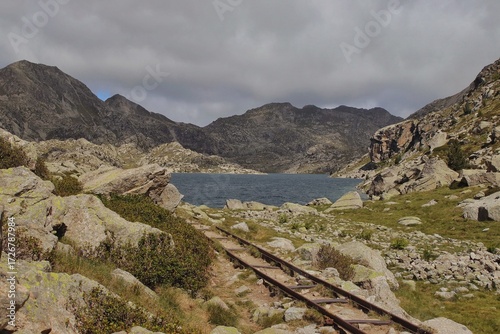 Lago de montaña con vía de tren