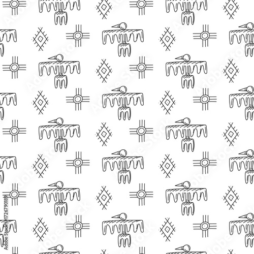 A pattern of birds and symbols of native American settlements. Seamless texture in doodle style. A flying bird with wide wings with elements of writing. Rituals, worship. American Indians