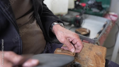 Old shoe master renews the shoe close up