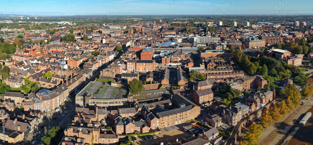Fototapeta premium Aerial panorama of Chester cityscape with dense rooftops, historic buildings, and skyline views.