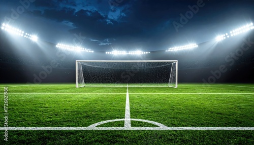 Empty soccer stadium at night, illuminated by spotlights.  Wet grass