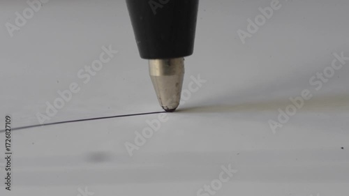 The tip of the inexhaustible pen draws lines on the paper as a macro