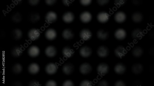 A sophisticated and cinematic abstract animation featuring a mesmerizing group of particles coalescing at the center of a pure black background.