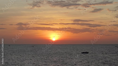 Aerial drone shot of Vietnam fishing boat, moving on tropical sea waves under sunrise sky. Royalty high-quality free best stock of fishermen’s heading offshore in calm ocean waves, cultural seascape