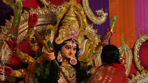 Bengali women performing pooja and sindoor khela rituals with Goddess Durga during traditional Durga Puja celebrations.