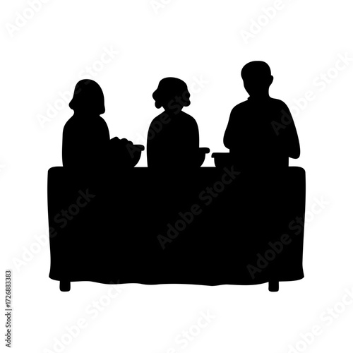 Silhouette of three people serving food at a long table