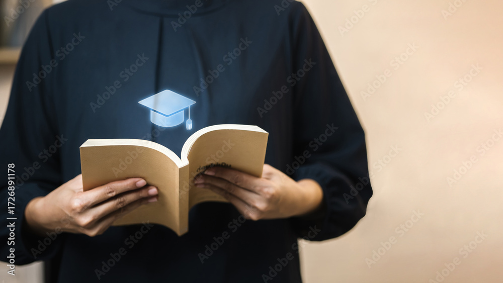 Obraz premium Graduation cap hologram above book, education and e-learning inspiration