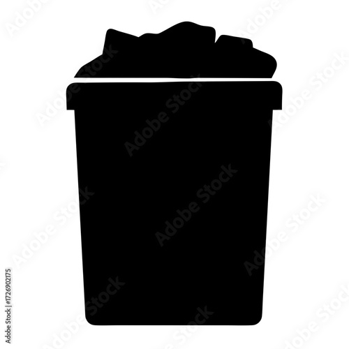 A simple black silhouette of a full trash can on white background