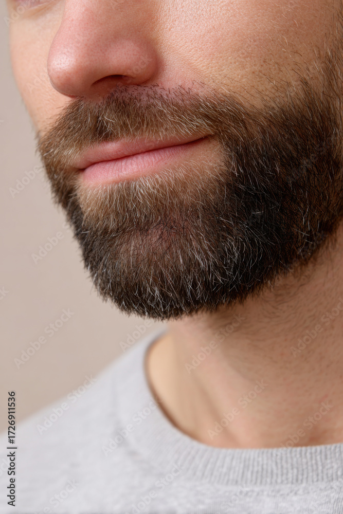 Obraz premium Close up of content man well groomed beard and mustache. detail of male facial hair, skin care, and grooming with neat chin and soft light on caucasian adult
