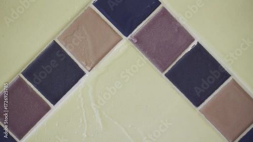 Clear water on colored tiles