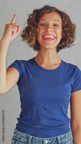 Inspired smiling student raising finger with aha expression showing creative insight moment. Perfect for innovation and creativity content,  isolated white background 
